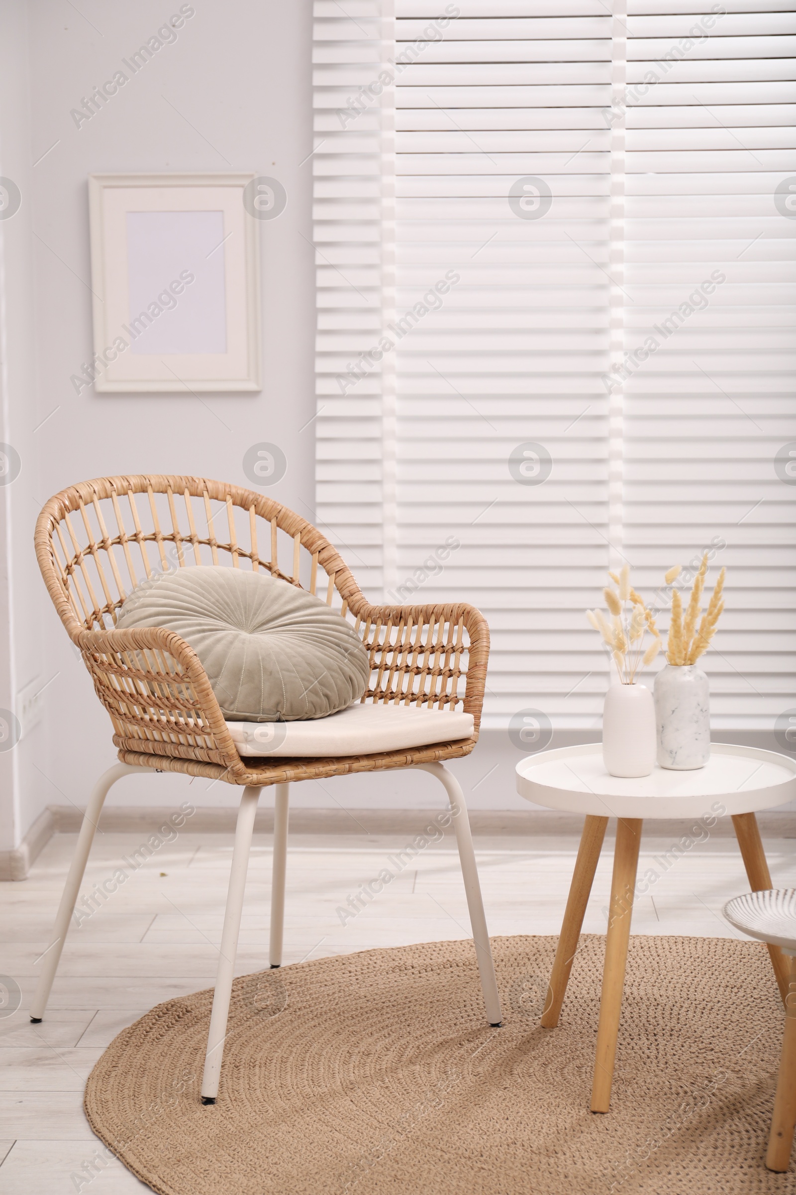 Photo of Comfortable armchair and side table in living room. Interior design