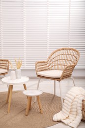 Photo of Comfortable armchairs and tables in living room. Interior design