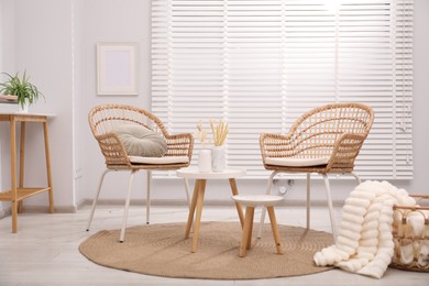 Photo of Comfortable armchairs and other furniture in living room. Interior design