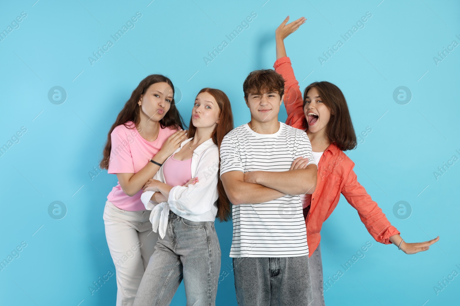 Photo of Portrait of happy teenage friends on light blue background