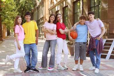 Photo of Portrait of happy teenage friends together outdoors