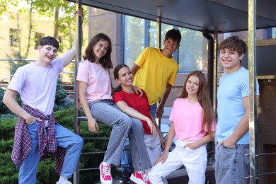 Photo of Portrait of happy teenage friends spending time together outdoors