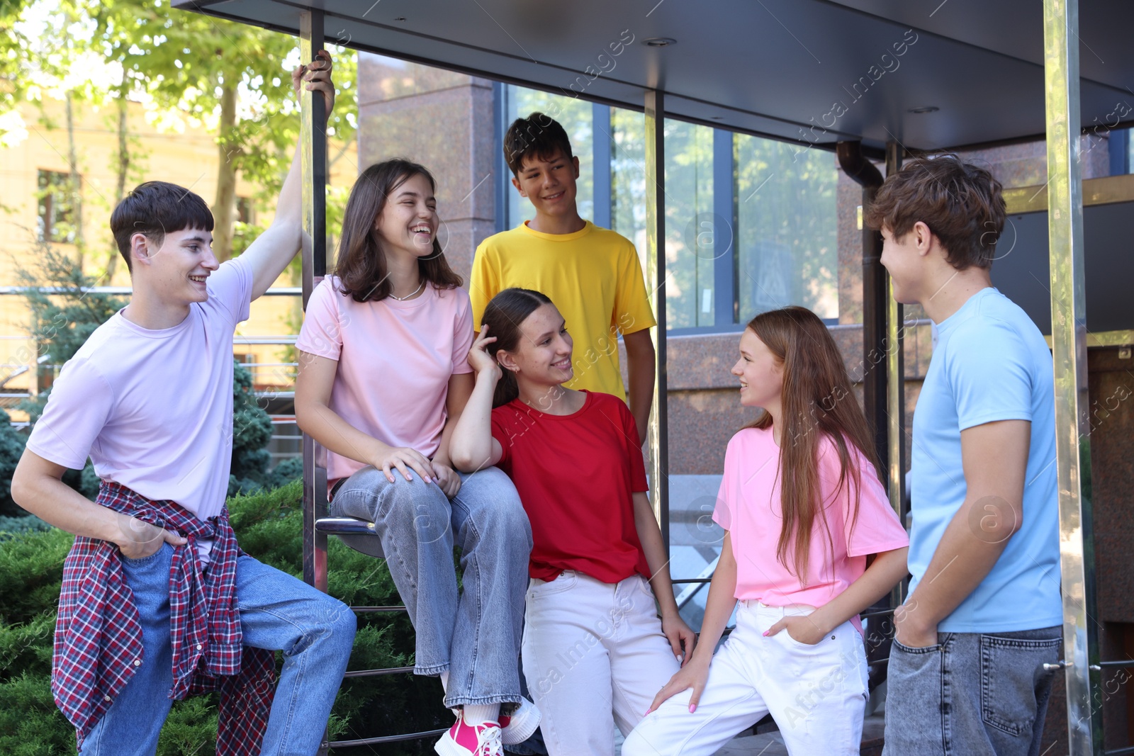 Photo of Group of happy teenage friends spending time together outdoors