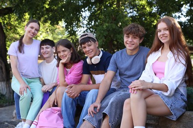 Photo of Portrait of happy teenage friends together outdoors
