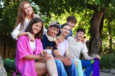 Photo of Portrait of happy teenage friends together outdoors