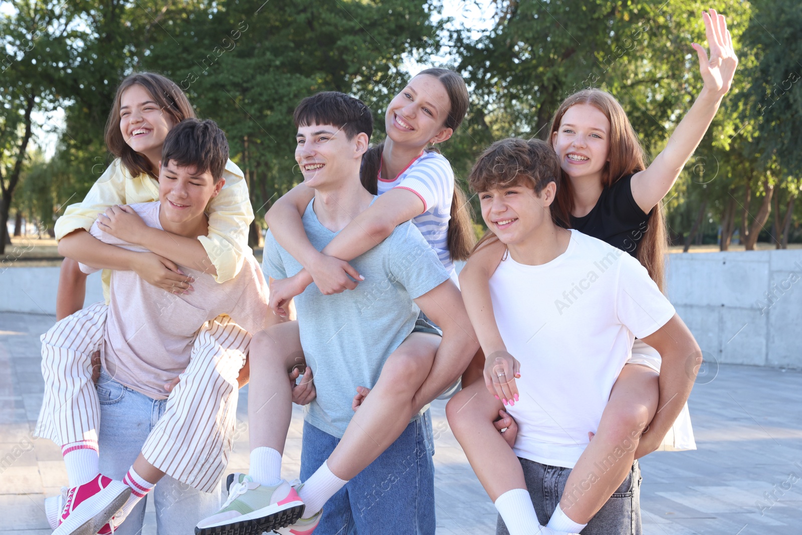 Photo of Group of happy teenage friends spending time together outdoors