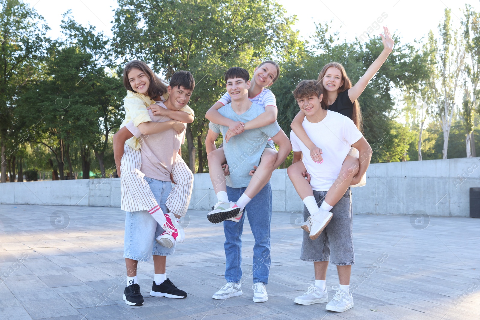 Photo of Group of happy teenage friends spending time together outdoors
