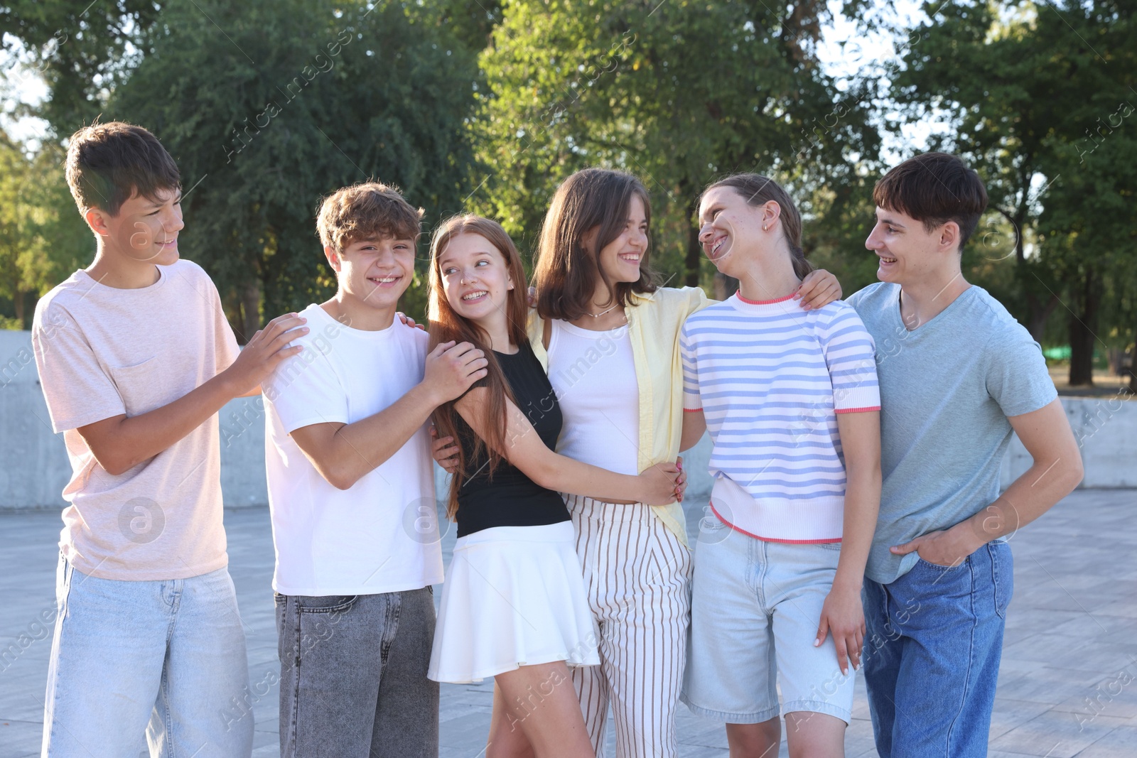 Photo of Portrait of happy teenage friends spending time together outdoors