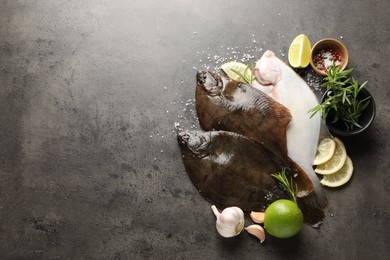 Photo of Fresh flounder fish, spices and products on grey textured table, flat lay with space for text. Raw seafood