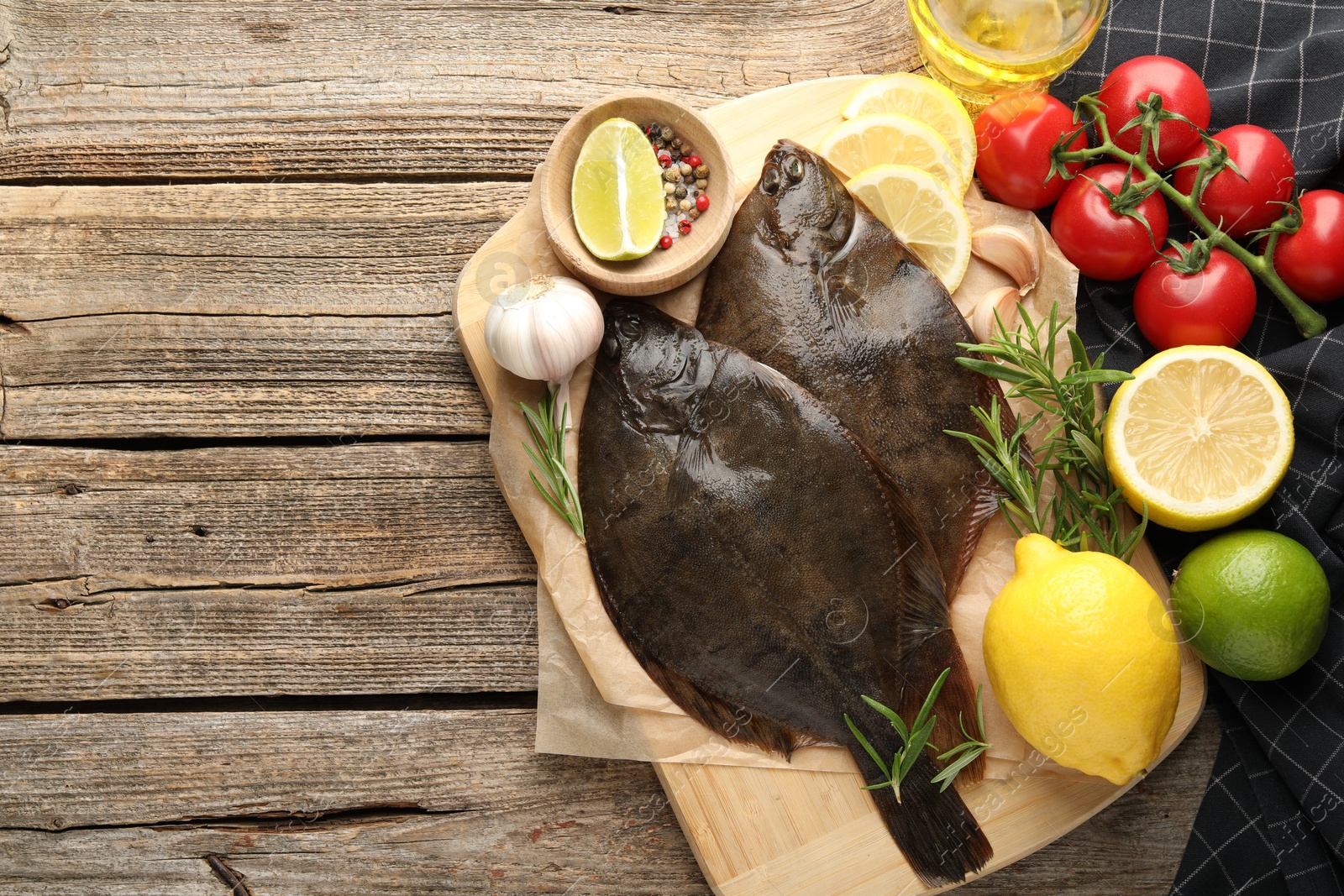 Photo of Fresh flounder fish, spices and products on wooden table, flat lay with space for text. Raw seafood