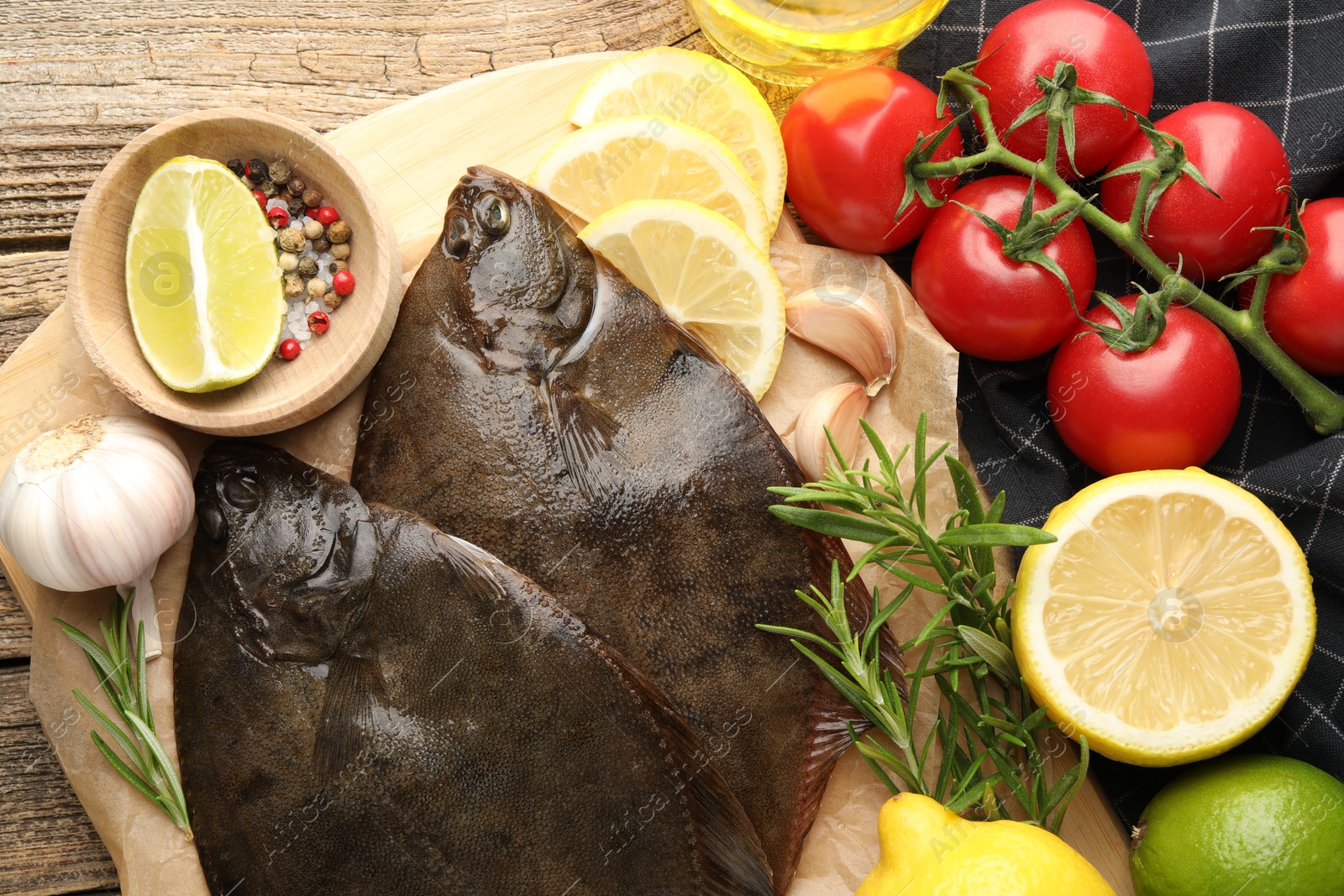 Photo of Fresh flounder fish, spices and products on wooden table, flat lay. Raw seafood