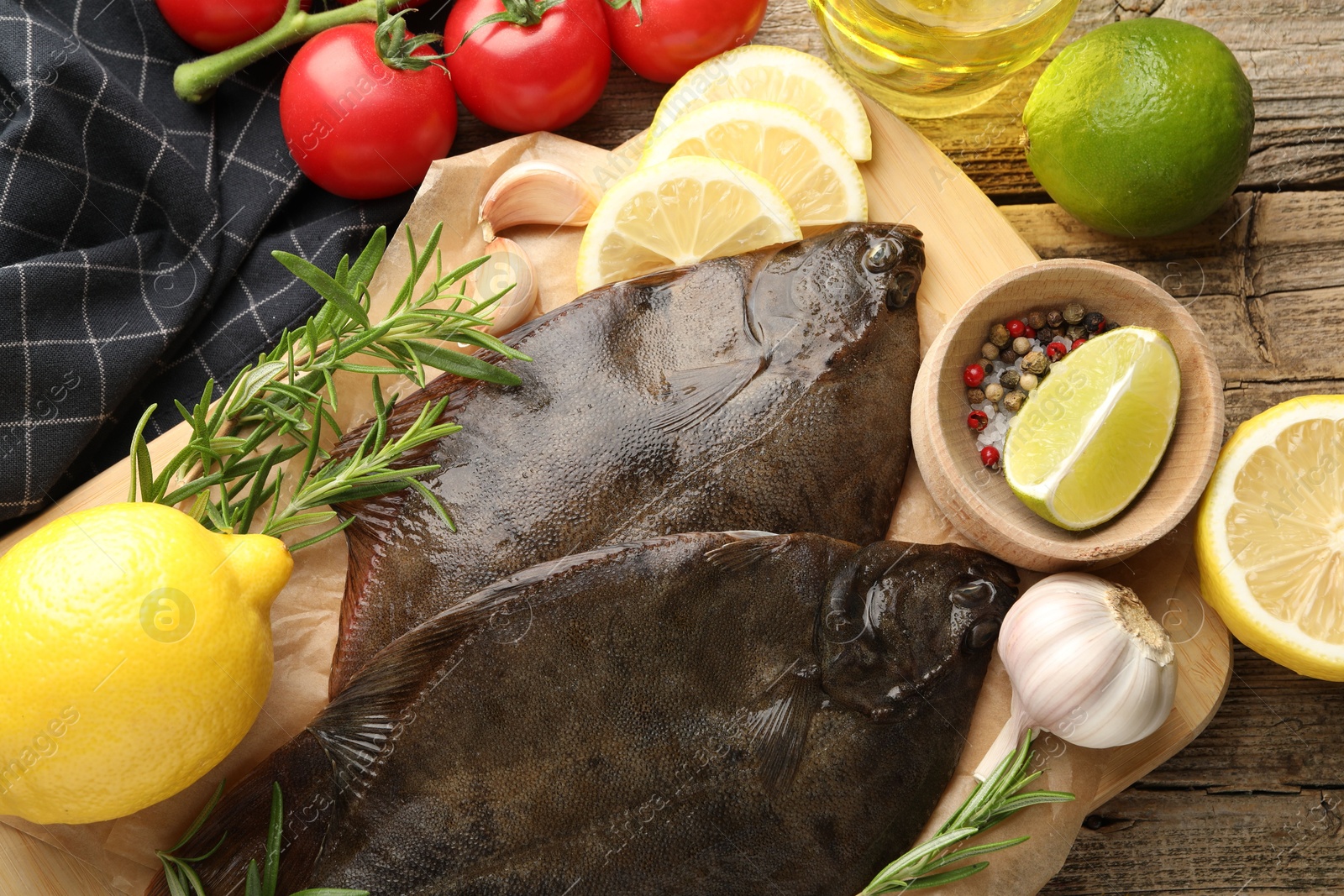 Photo of Fresh flounder fish, spices and products on wooden table, flat lay. Raw seafood
