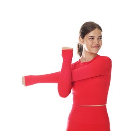 Photo of Teenage girl in sportswear stretching on white background