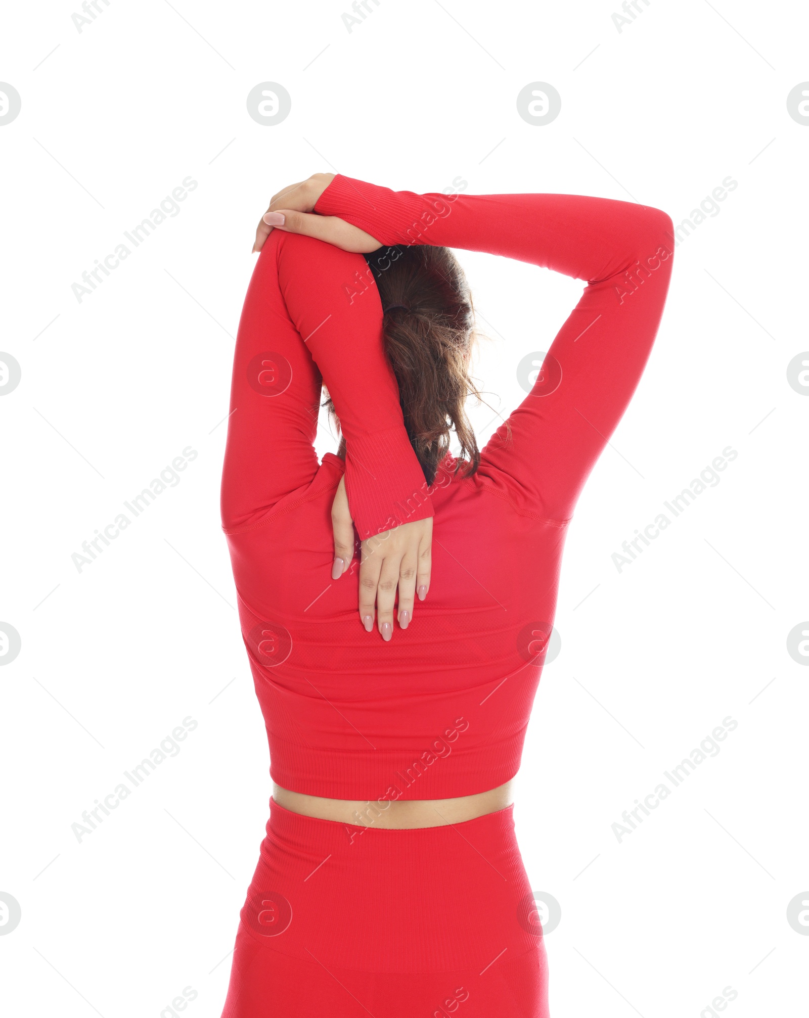 Teenage girl in sportswear stretching on white background, back view Photo of Teenage girl in sportswear stretching on white background, back view