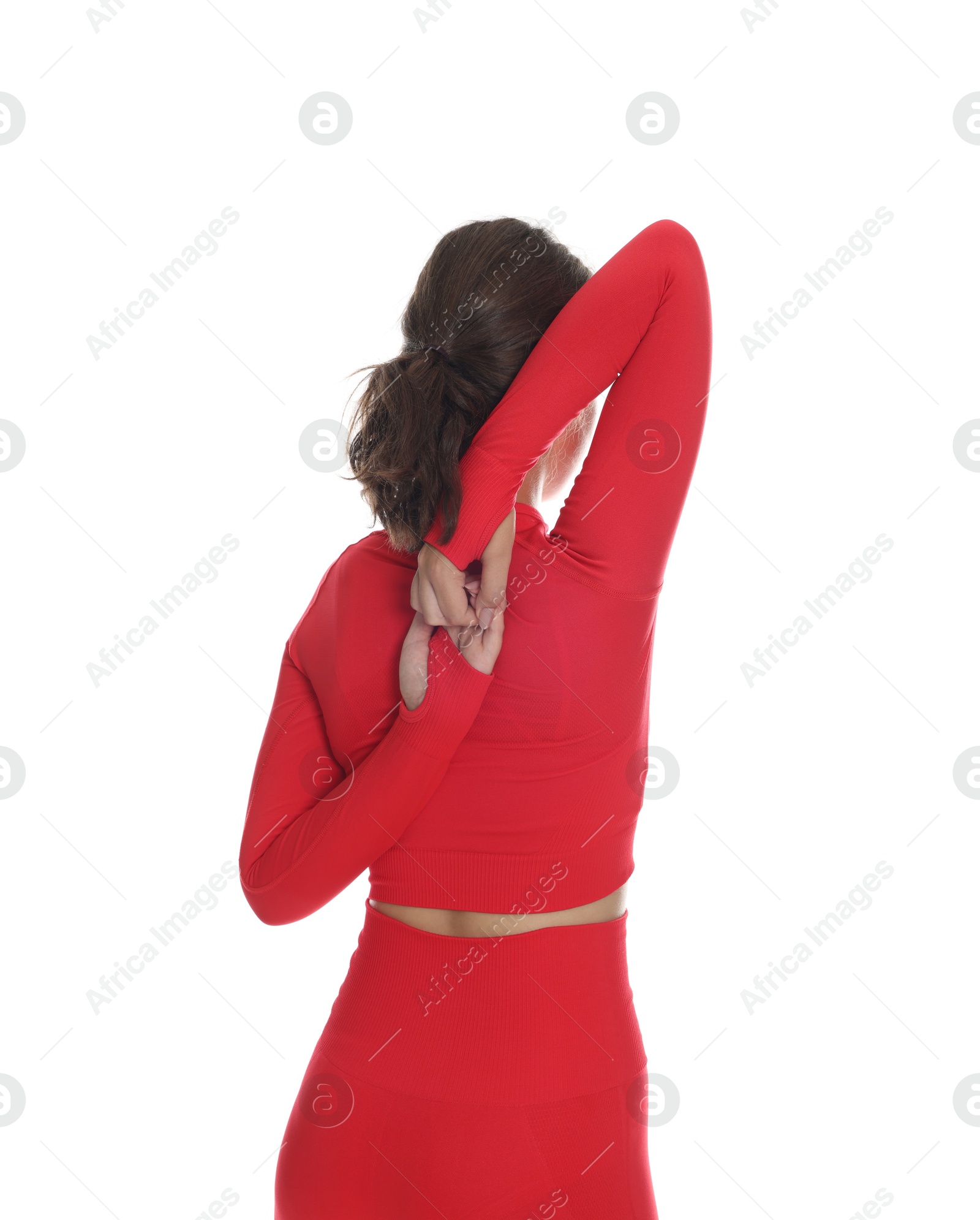 Teenage girl in sportswear stretching on white background, back view Photo of Teenage girl in sportswear stretching on white background, back view
