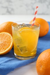 Photo of Refreshing soda water with orange slice in glass and fresh fruits on white wooden table, closeup