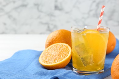 Photo of Refreshing soda water with orange slice in glass and fresh fruits on table, closeup. Space for text