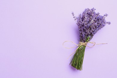 Photo of Bunch of beautiful lavender flowers on violet background, top view. Space for text