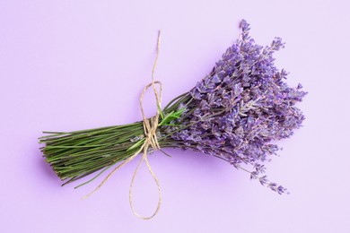 Photo of Bunch of beautiful lavender flowers on violet background, top view