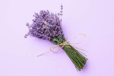 Photo of Bunch of beautiful lavender flowers on violet background, top view