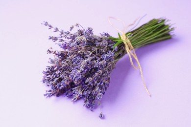 Photo of Bunch of beautiful lavender flowers on violet background, closeup