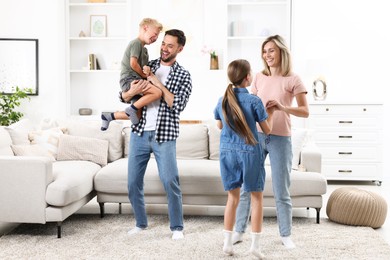 Photo of Happy family having fun in light room