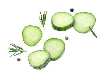 Image of Cucumber slices and rosemary flying against white background