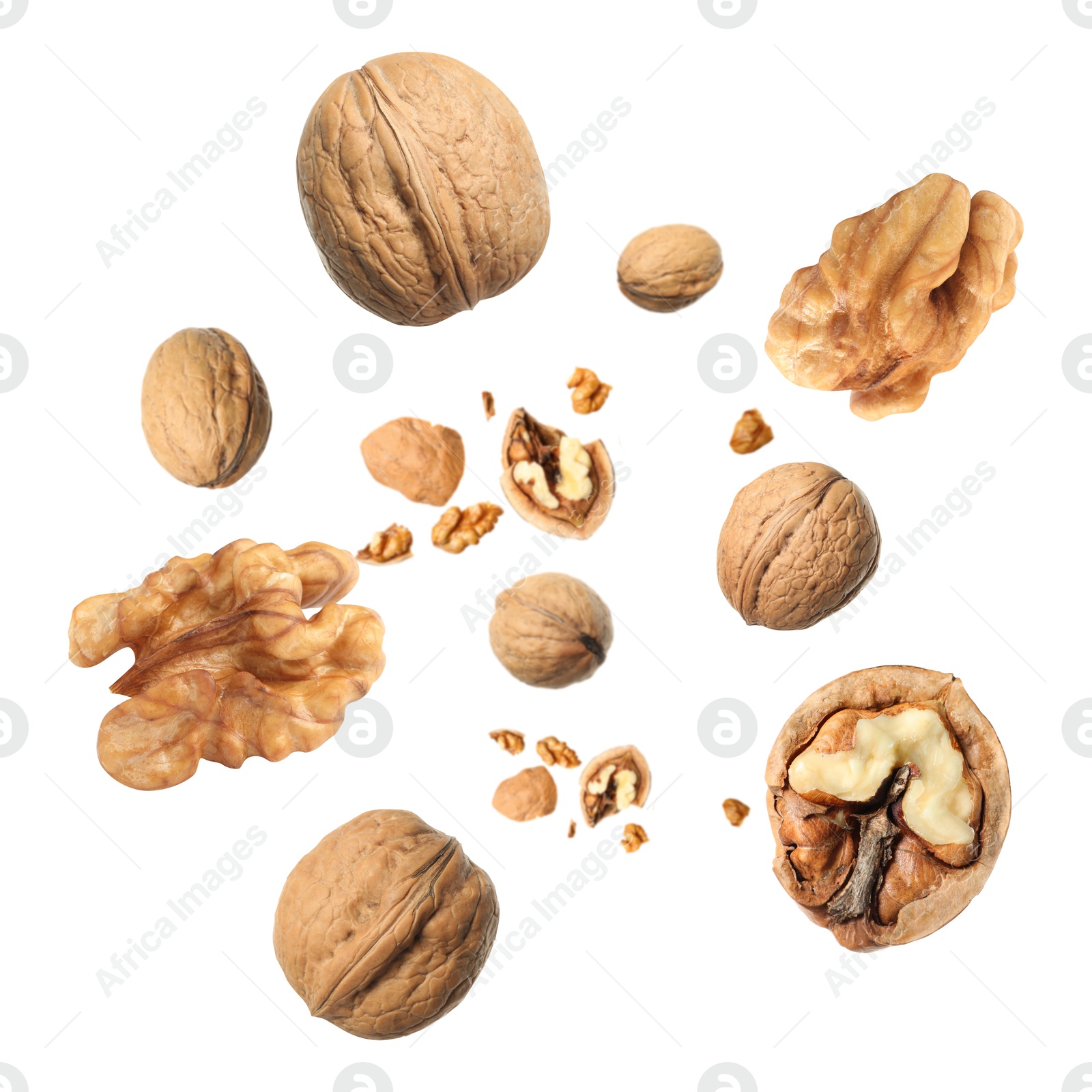 Image of Walnuts swirling in air against white background