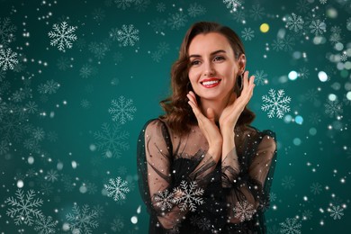 Image of Smiling woman with perfect makeup on teal background with snowflakes