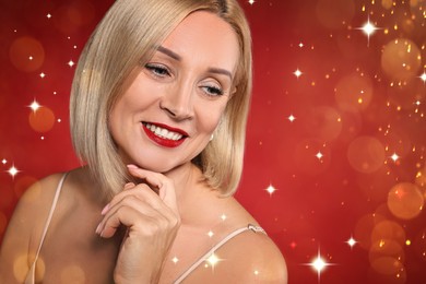 Image of Smiling woman with perfect makeup on red background with magic lights