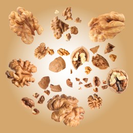 Image of Walnuts swirling in air against pale brown background