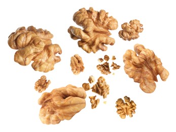 Image of Walnuts swirling in air against white background