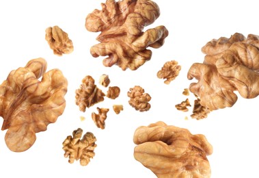 Image of Walnuts swirling in air against white background