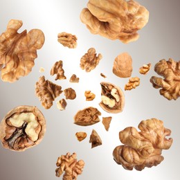 Image of Walnuts swirling in air against grey gradient background