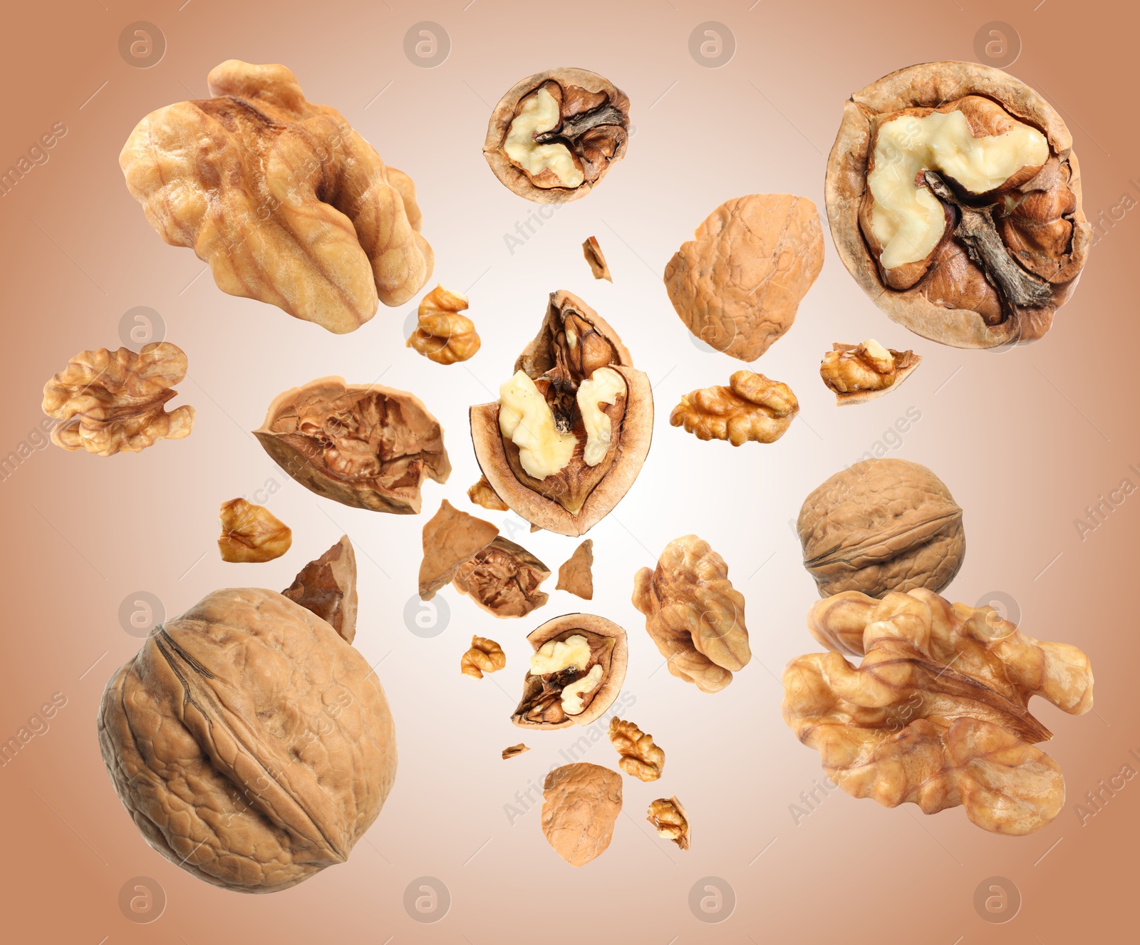 Image of Walnuts swirling in air against pale brown background