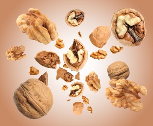 Image of Walnuts swirling in air against pale brown background