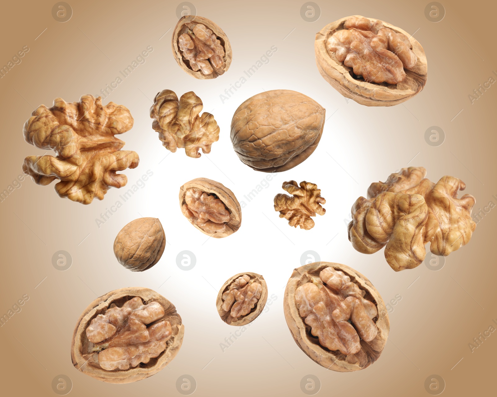 Image of Walnuts swirling in air against pale brown background