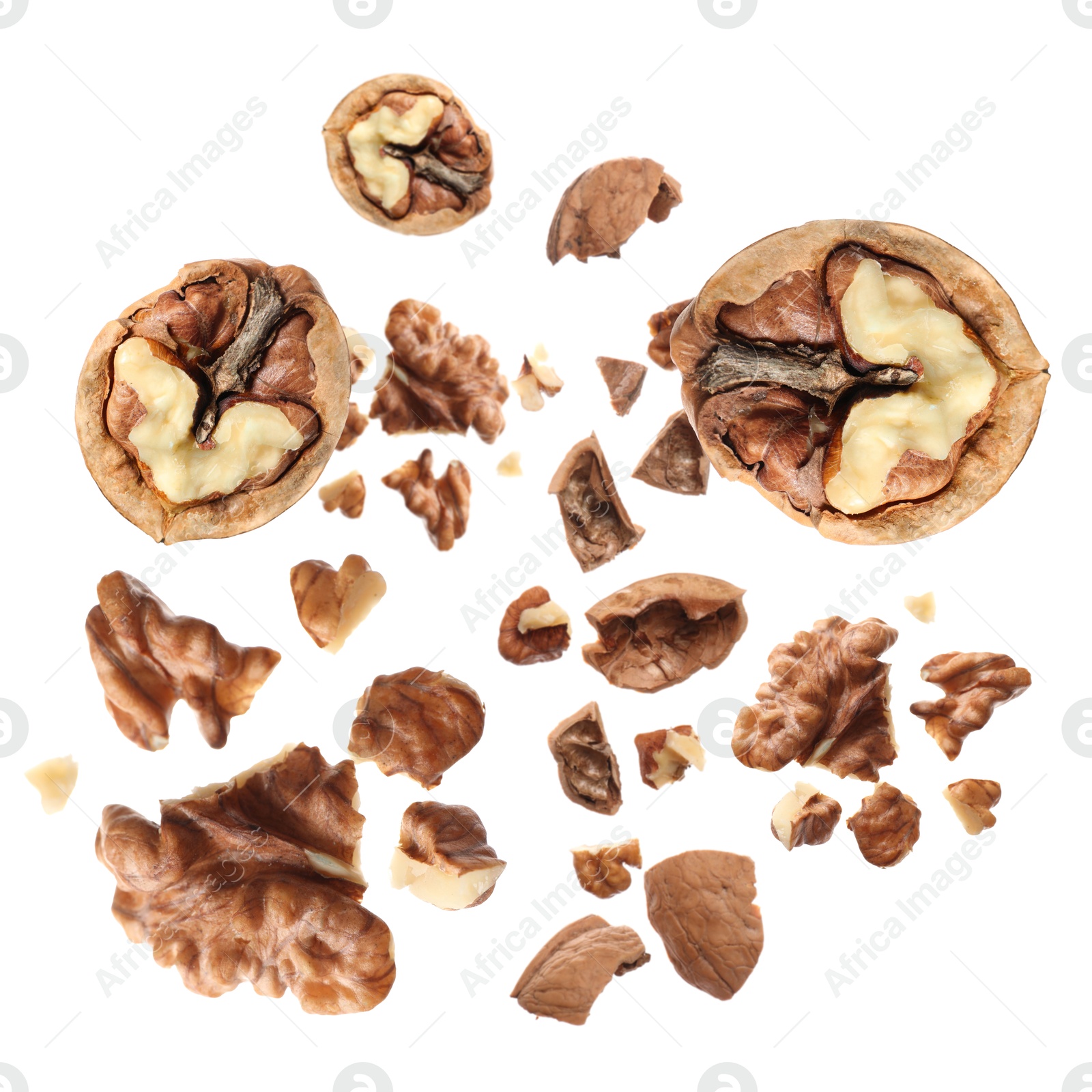 Image of Walnuts swirling in air against white background