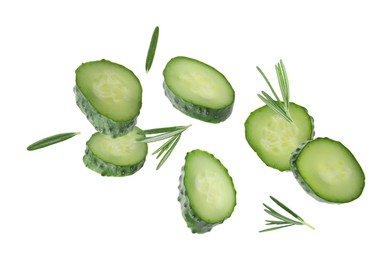 Image of Cucumber slices and rosemary flying against white background