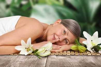 Image of Beautiful woman relaxing on bamboo mat against blurred green background. Spa center