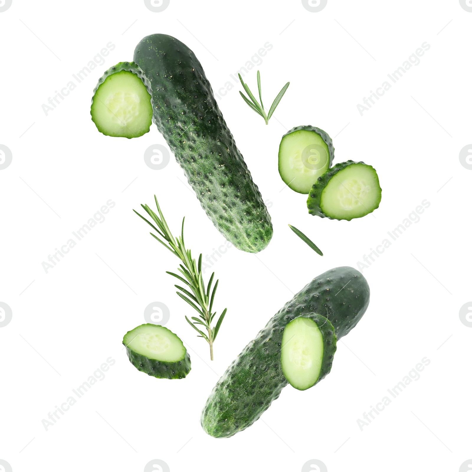 Image of Fresh cucumbers and rosemary falling against white background