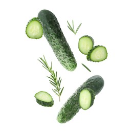 Image of Fresh cucumbers and rosemary falling against white background