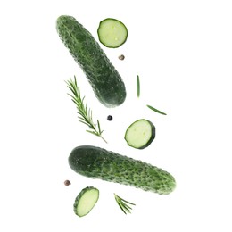 Image of Fresh cucumbers and rosemary falling against white background