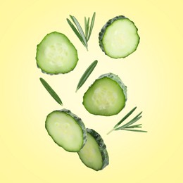 Image of Cucumber slices and rosemary flying against beige background