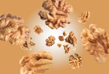 Image of Walnuts swirling in air against pale brown background
