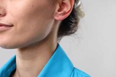 Photo of Closeup view of woman on light grey background