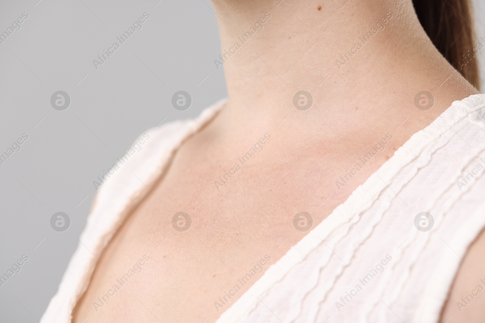 Photo of Closeup view of woman on light grey background
