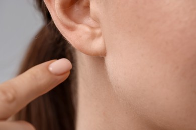 Photo of Closeup view of woman on grey background
