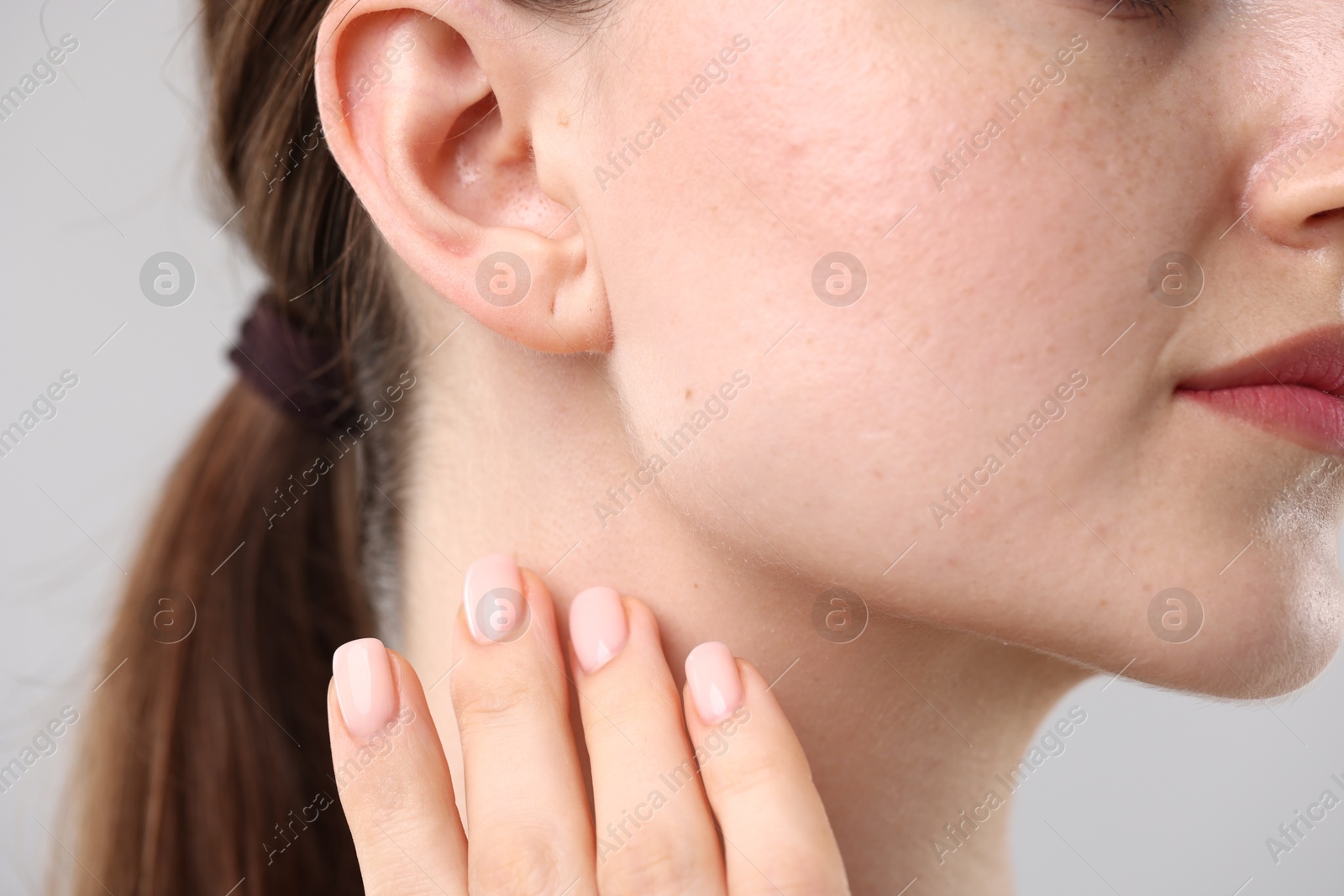 Photo of Closeup view of woman on light grey background