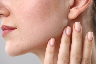 Photo of Closeup view of woman on light grey background